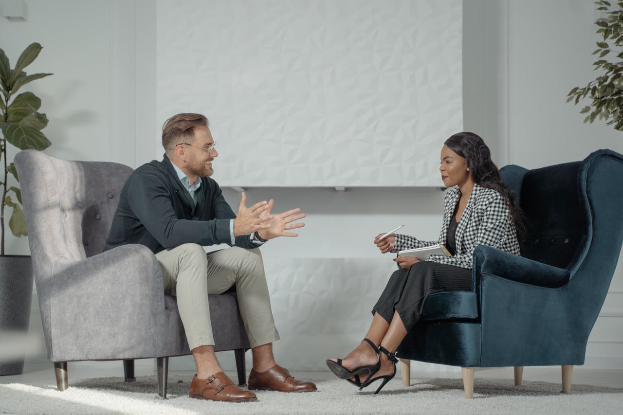 A candid interaction between a man and woman during a professional interview in a modern office setting.