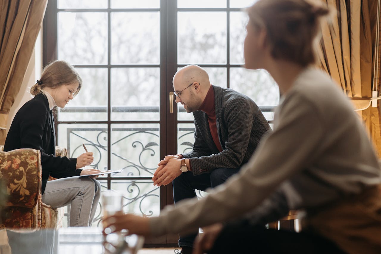 A psychologist and teenage patient in a counseling session, focusing on mental health support.